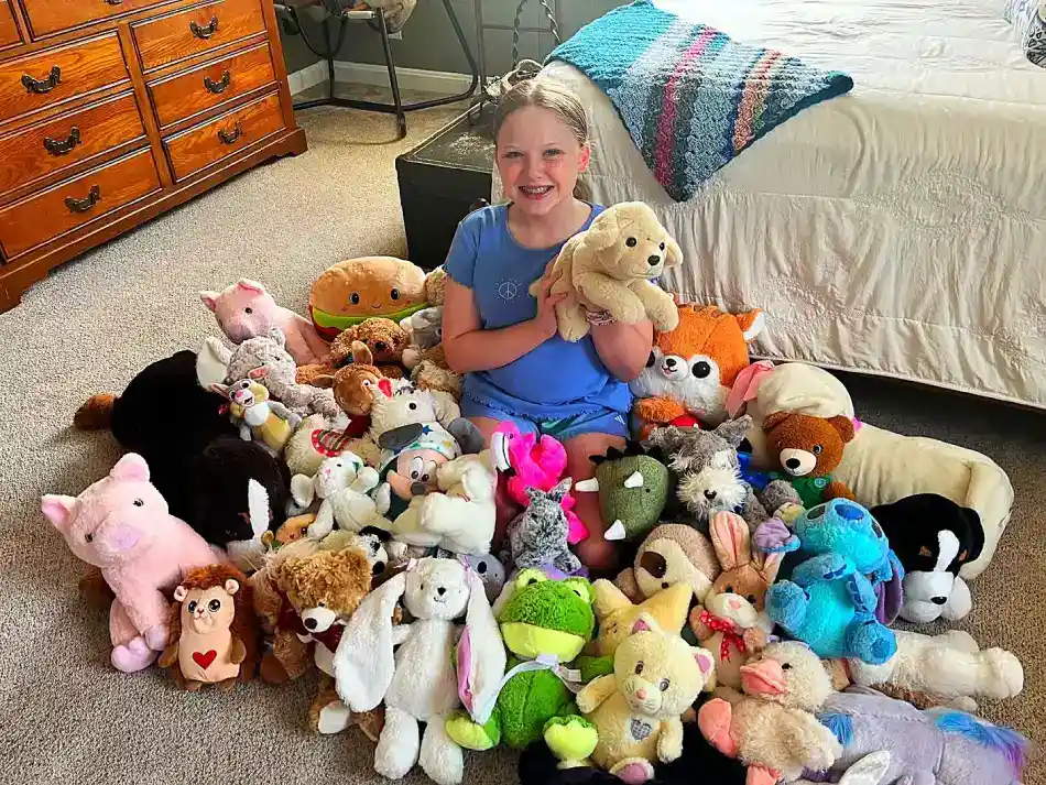girl repairs stuffed animals