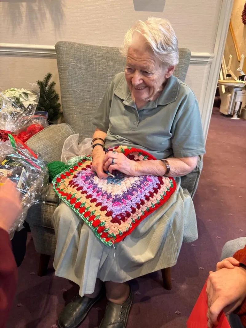 woman crochets blankets babies